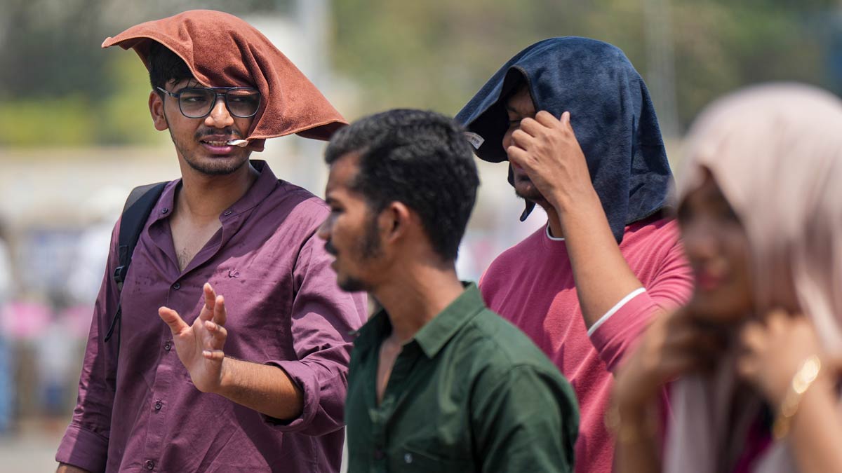 People cover themselves amid heat during the summer season, in Mumbai | PTI