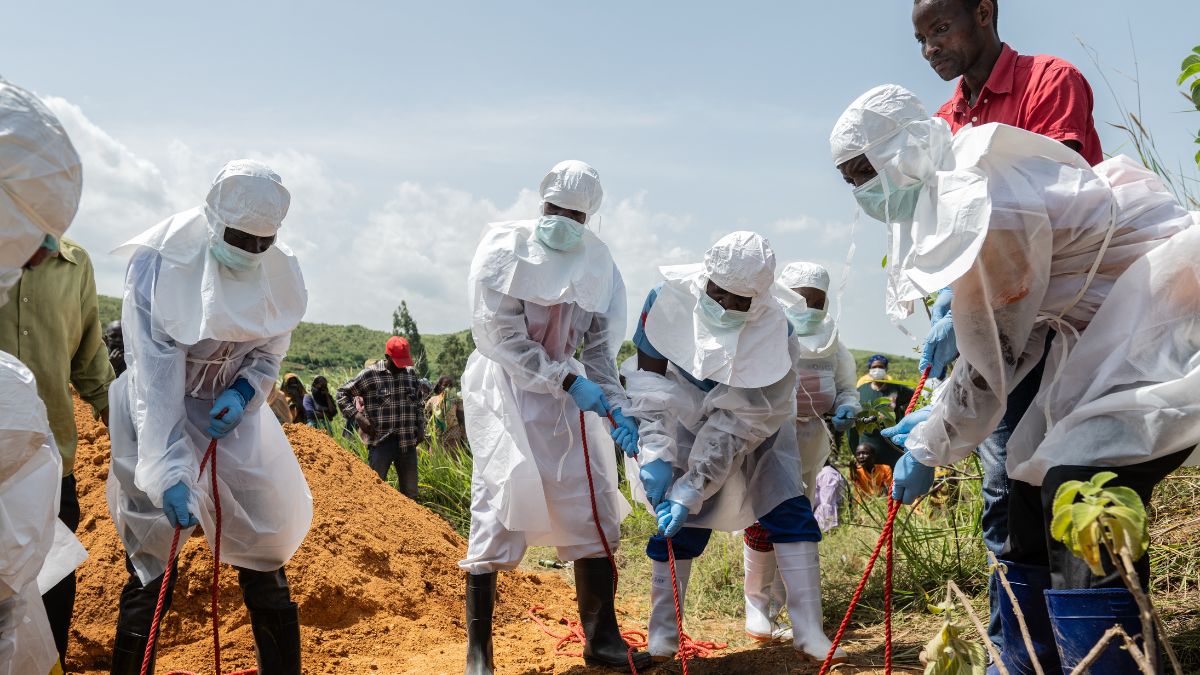 Red Cross workers bury an Ebola victim at the Rwampara Cemetery, in Rwampara, Congo | AP