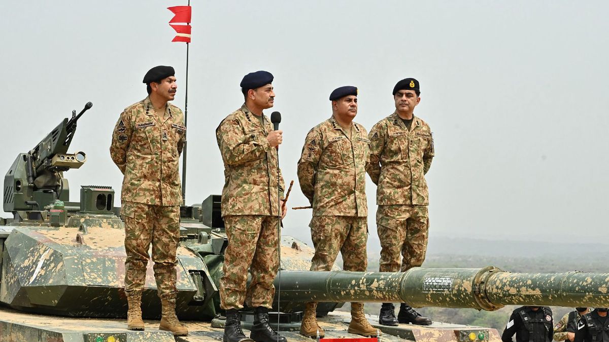 Pakistan Army Chief General Syed Asim Munir (2L) stands on military tank whicle speaking with army troops in Jhelum, Punjab province | AFP