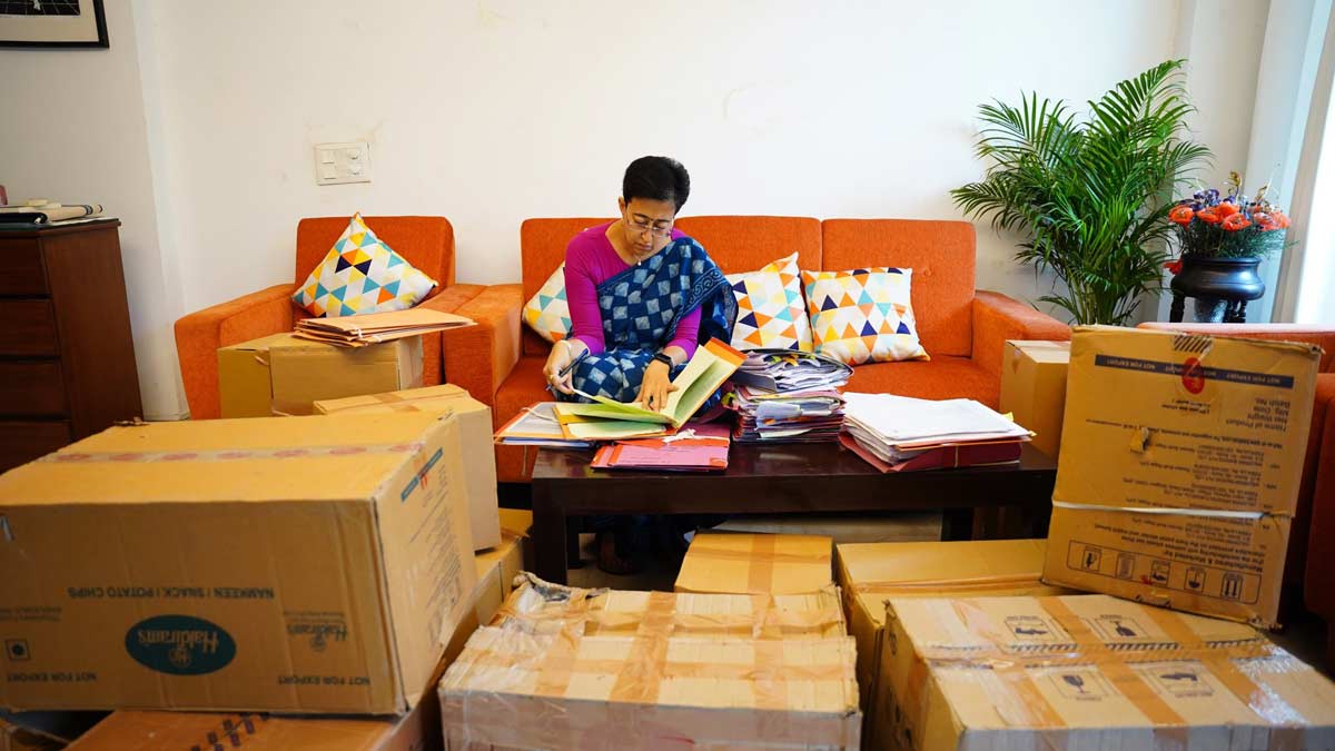 Atishi signing files at her Kalkaji residence surrounded by packed cartons | X