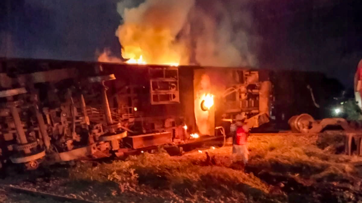 Smoke and flame out of a derailed coach | PTI Smoke and flame out of a derailed coach | PTI