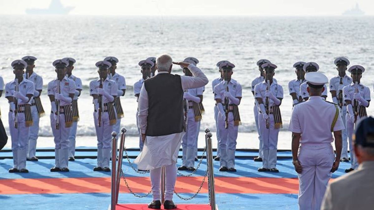 PM Narendra Modi inspects the guard of honour during the Navy Day ceremony on Tarkarli beach in Sindhudurg, Maharashtra