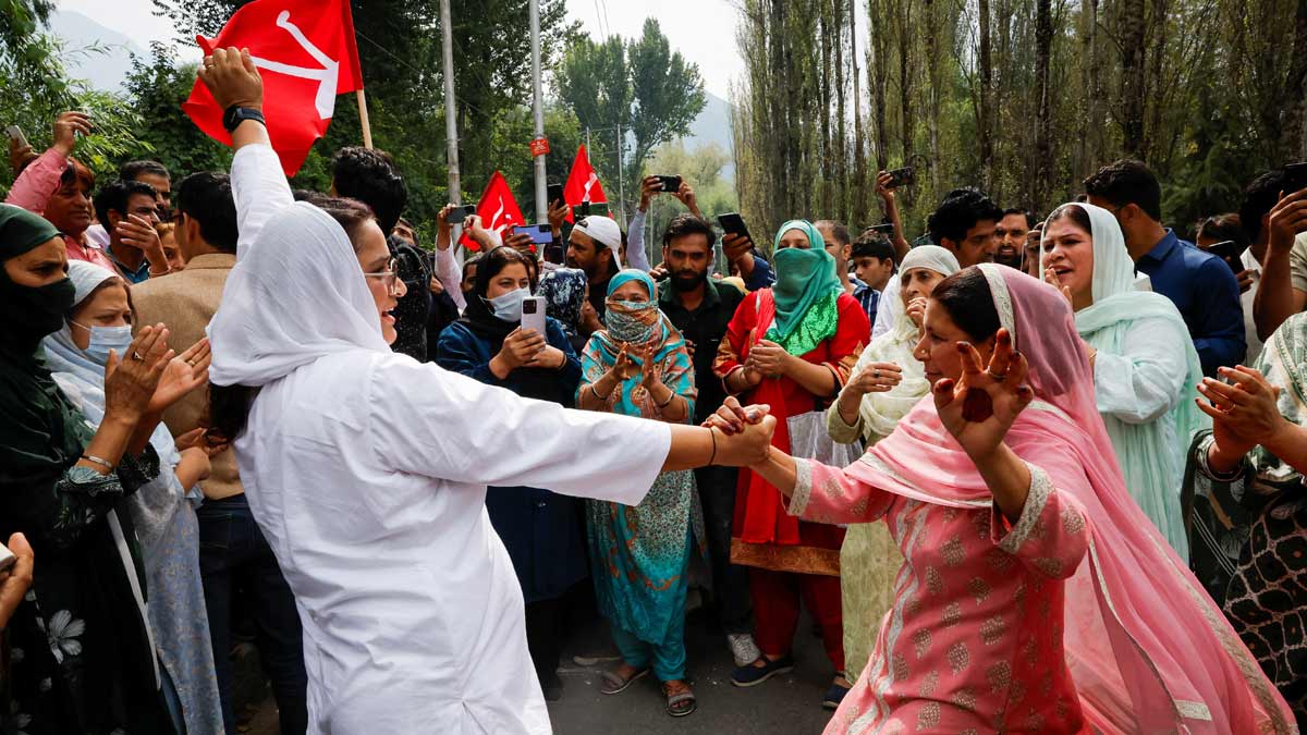 Supporters of the Jammu and Kashmir National Conference party celebrate outside the vote counting centre on the day of the assembly election results, in Srinagar | PTI 