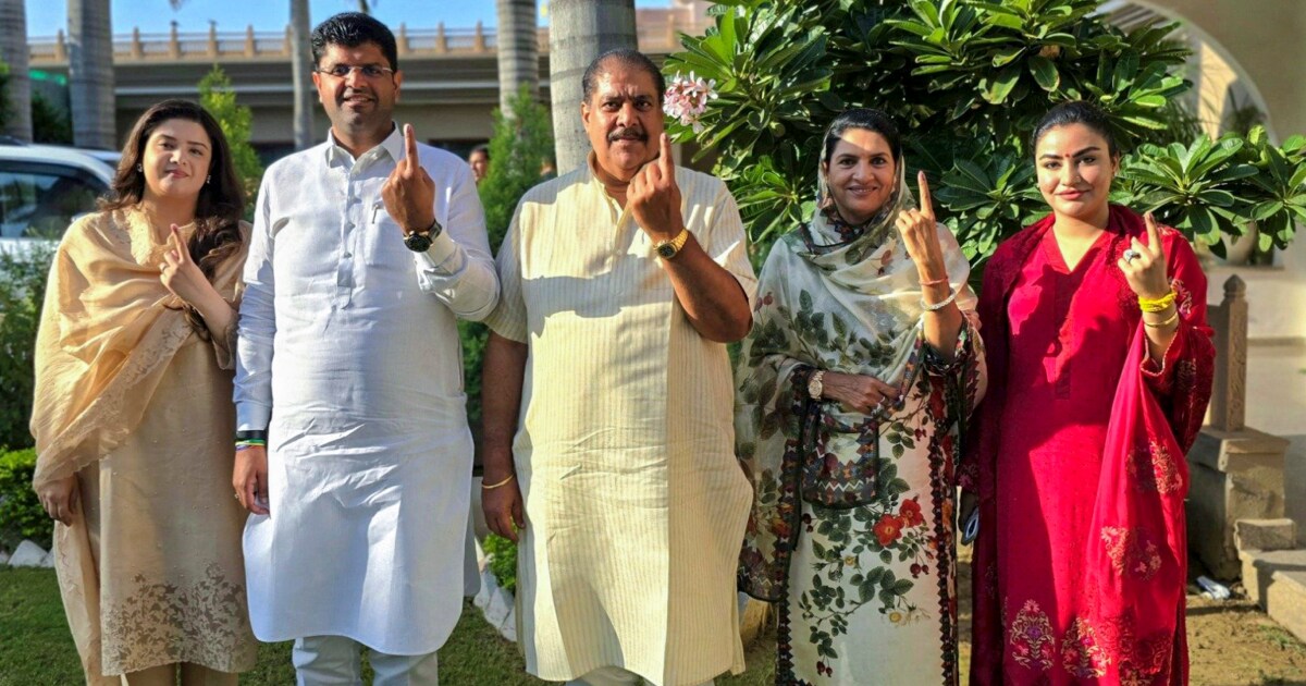Jannayak Janta Party (JJP) leader Dushyant Chautala and his family members show their fingers marked after casting votes at a polling station in Sirsa | PTI
