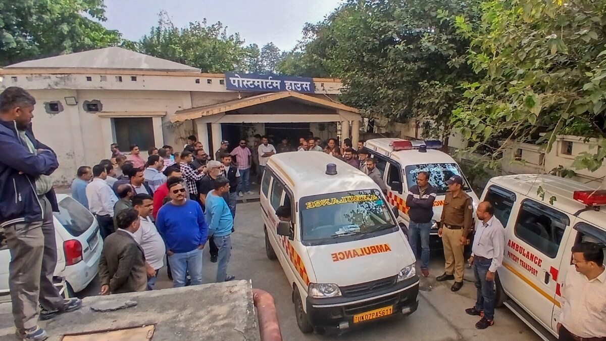 Relatives of the victims and police personnel at the mortuary of Coronation Hospital, following a road accident involving a car and a truck in Dehradun | PTI