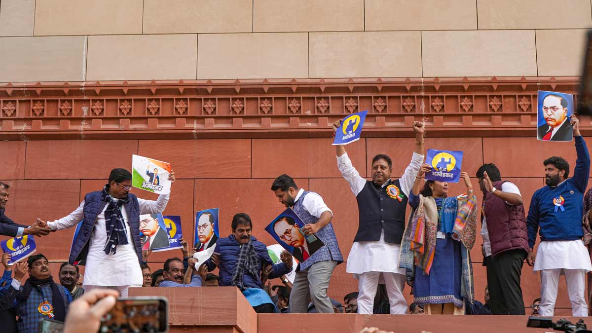 NDIA Bloc MPs climb the wall of Makar Dwar during their protest march demanding an apology and resignation of Union Home Minister Amit Shah | PTI