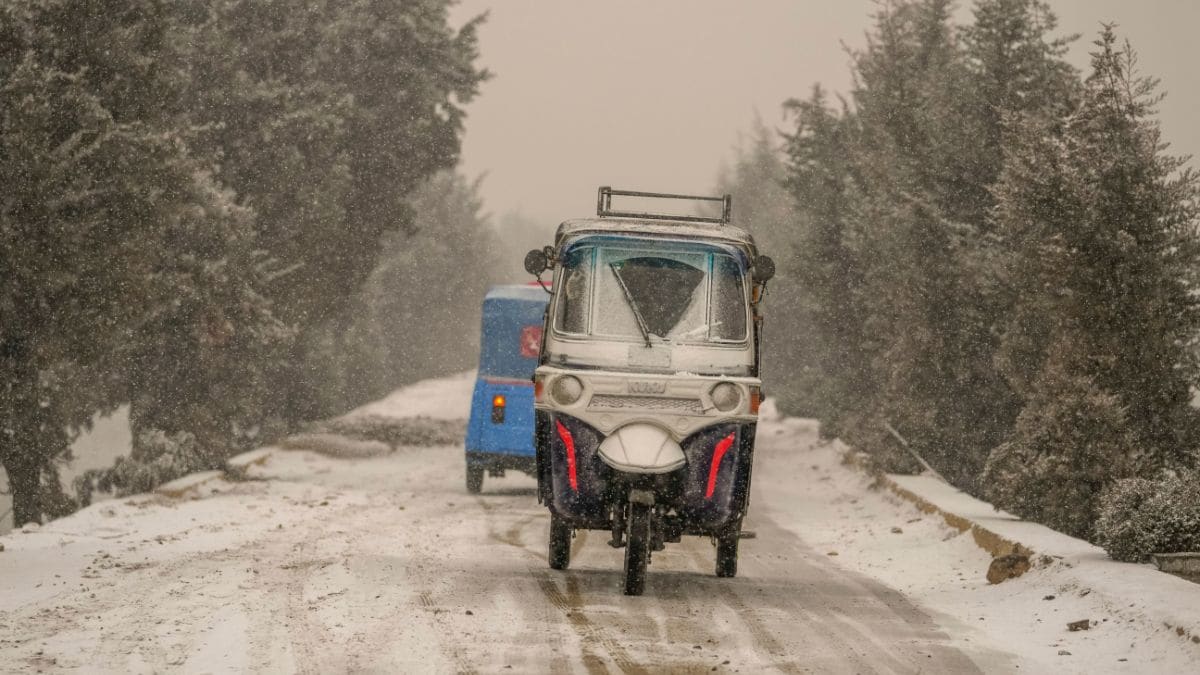 An auto-rickshaw drives on a snow-covered road | AP