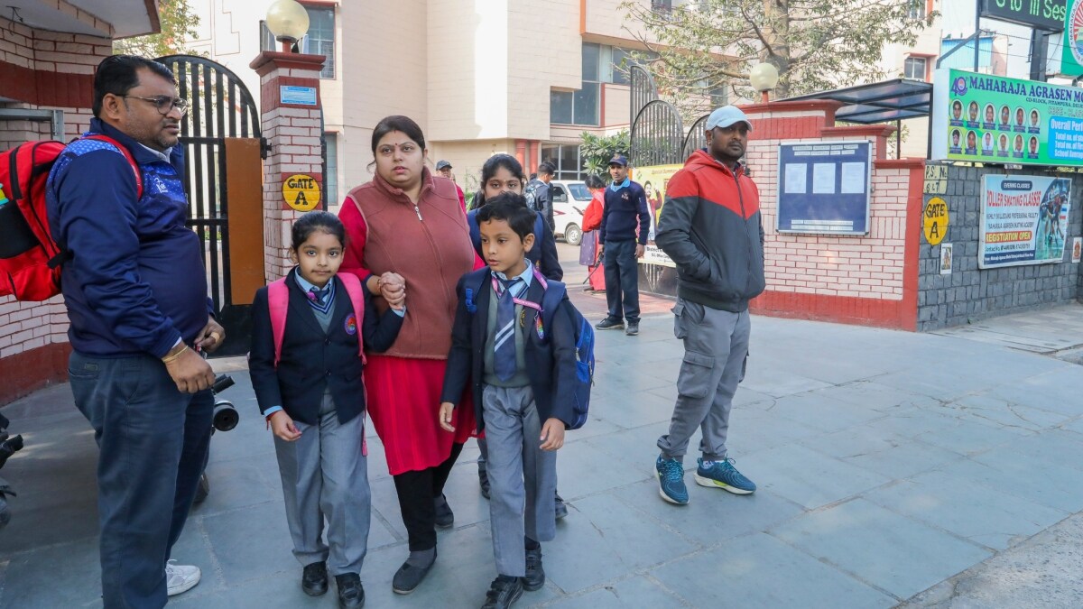 Students leave with their guardians after around 40 schools in Delhi received a bomb threat mail, in New Delhi | PTI