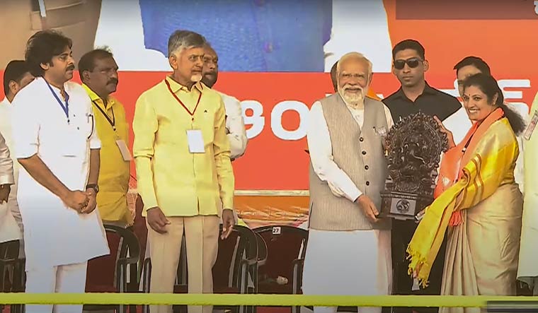 Prime Minister Narendra Modi being presented a memento as TDP chief N. Chandrababu Naidu and Jana Sena chief Pawan Kalyan look on during a public meeting in Palnadu | PTI