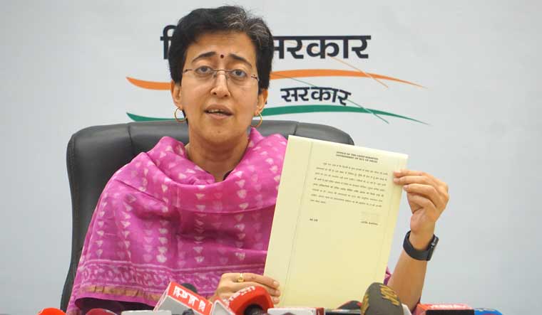 Delhi Minister and AAP leader Atishi Singh shows Delhi Chief Minister Arvind Kejriwal's first direction from ED custody on running the city government during a press conference, in New Delhi | PTI