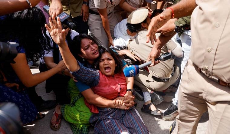 Police detain supporters of the Aam Aadmi Party during a protest against Arvind Kejriwal, in Delhi | Reuters