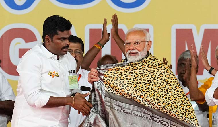 Prime Minister Narendra Modi being felicitated by Tamil Nadu BJP President K. Annamalai during a public meeting | PTI