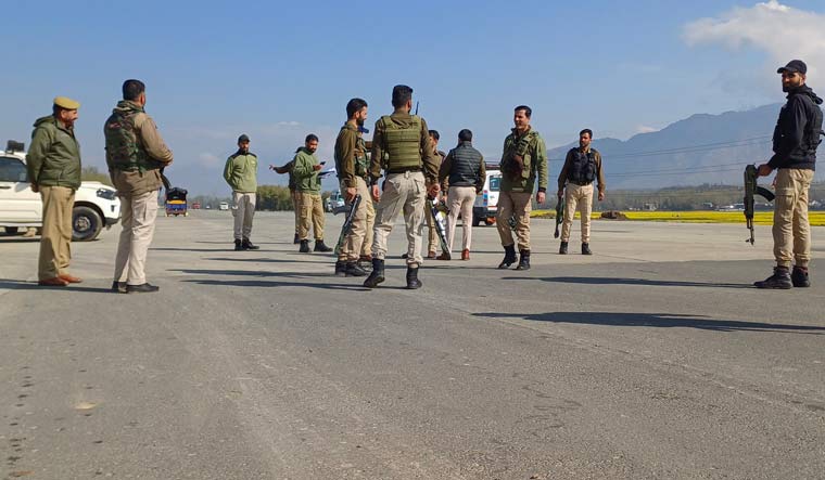 Security personnel stand guard along the Jammu-Srinagar National Highway after security was beefed up ahead of landing and take-off trials on the newly constructed emergency runway at Bijbehara, in Anantnag district | PTI