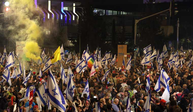 Israeli anti-government demonstrators protest demanding a secure release of hostages held by the Palestinian Hamas movement in the Gaza Strip | AFP

