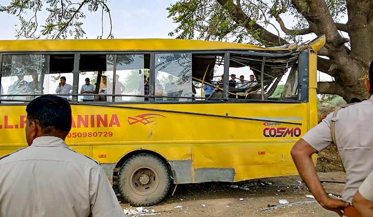  Locals near a damaged school bus after an accident near Mahendragarh, in Narnaul district, Haryana | PTI