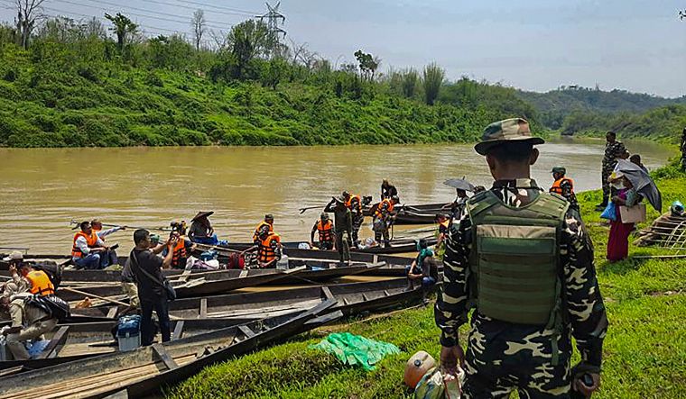 Polling officials travel via boats to reach their respective polling booths, a day before the voting in the second phase of Lok Sabha elections, in Jiribam district, Manipur | PTI