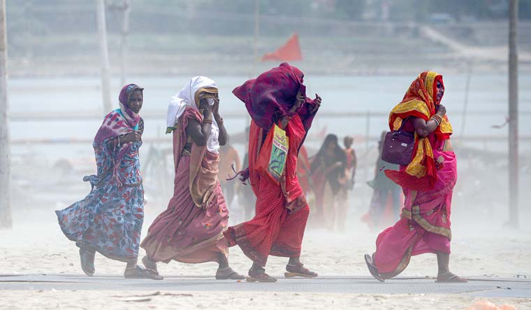 People cover themselves for protection against the heat wave in Prayagraj | PTI