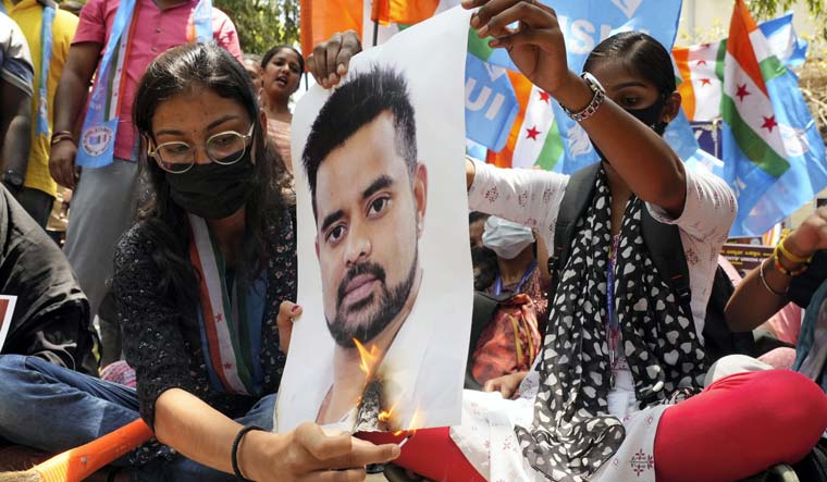 NSUI members burn a poster of JD(S) MP Prajwal Revanna during a protest against his alleged involvement in a sexual abuse case, in Bengaluru | PTI