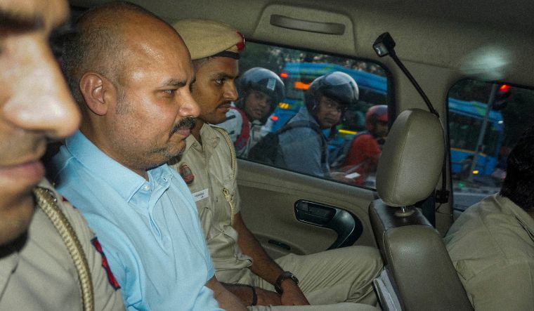 Delhi Police personnel with Bibhav Kumar leave Kejriwal's residence after recreation of the scene in AAP MP Swati Maliwal's assault case in New Delhi on May 20, 2024 | PTI