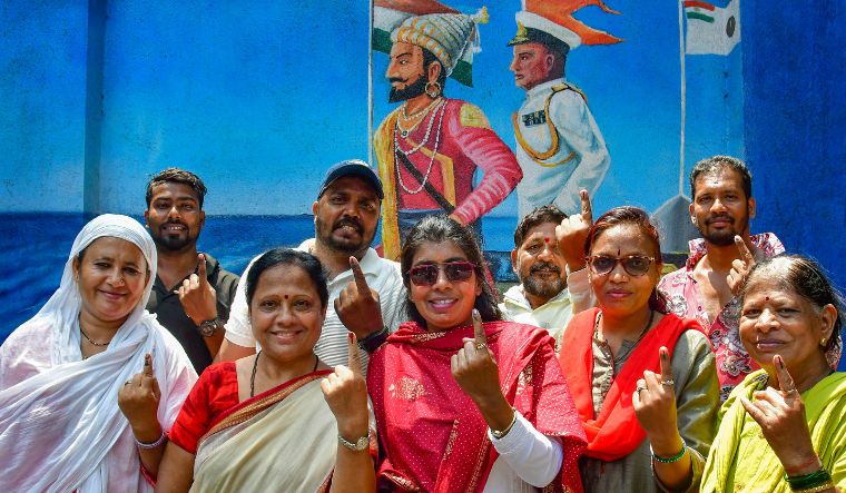 Voters show their fingers marked with indelible ink after casting their votes for the fifth phase of Lok Sabha elections, in Mumbai on May 20, 2024 | PTI