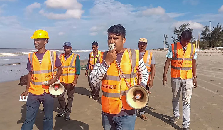 Personnel from West Bengal Disaster Management conduct announcements on the beach as part of precautionary measures ahead of the landfall of cyclone 'Remal', in South 24 Parganas district | PTI