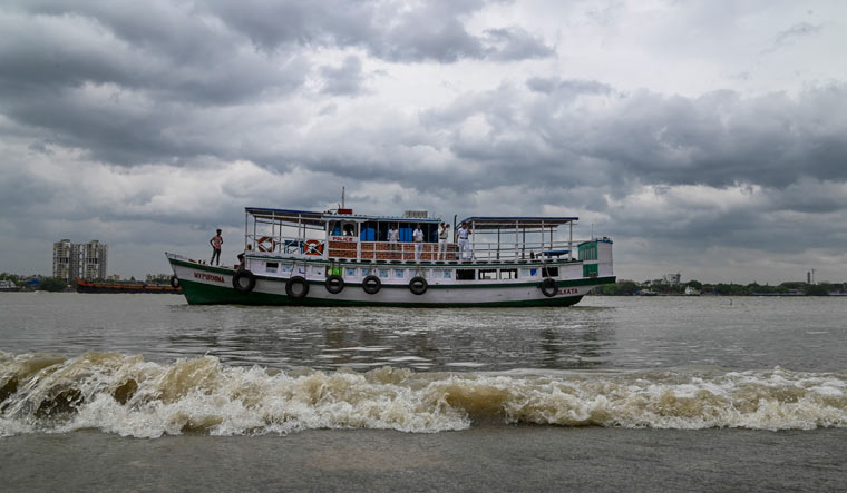 Police personnel make announcements ahead of cyclone Remals landfall at the Hooghly river, in Kolkata | PTI