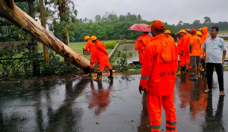 NDRF personnel remove an uprooted tree from a road after the landfall of Cyclone 'Remal', in South 24 Parganas district on May 27, 2024 | PTI