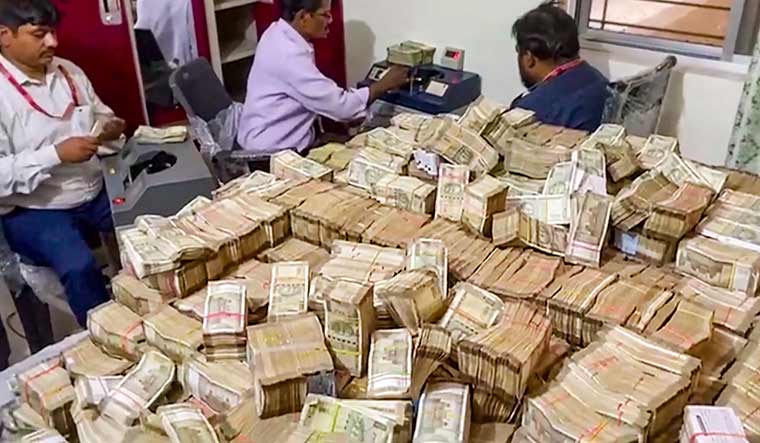 Officials of the Enforcement Directorate recover 'unaccounted' cash during searches at the premises of a domestic help allegedly linked to the secretary of Jharkhand minister Alamgir Alam, in Ranchi | PTI