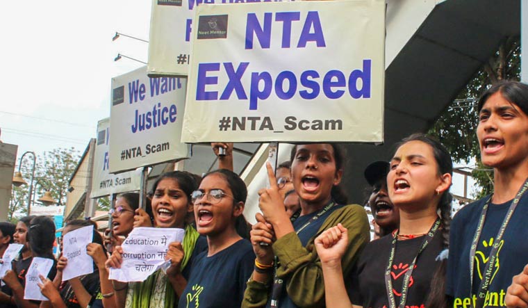 Students raise slogans during a protest over the alleged irregularities in NEET 2024 results, in Bhopal | PTI