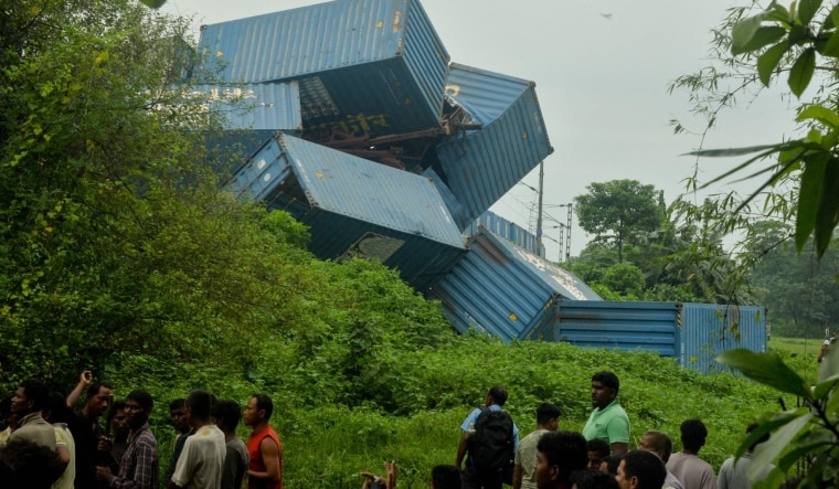 People gather near the carriages of a goods train after it collided with an passenger train in Nirmaljote, near Rangapani station | AFP