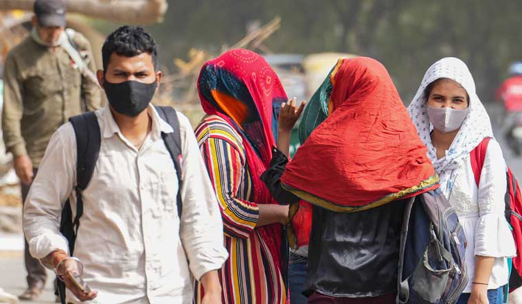 People cover their faces for protection from the scorching heat in New Delhi | PTI