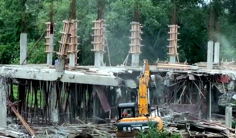 **EDS: SCREENSHOT VIA PTI VIDEOS** Guntur: An under construction central office of  YSRCP being demolished, at Tadepalli in Guntur district, Saturday, June 22, 2024. (PTI Photo) (PTI06_22_2024_000123B)