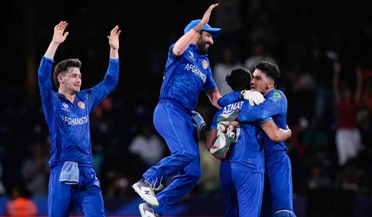 Afghanistan players celebrate after defeating Australia by 21 runs in their men's T20 World Cup cricket match at Arnos Vale Ground, Kingstown, Saint Vincent and the Grenadines, Saturday, June 22, 2024. (AP Photo/Ramon Espinosa)