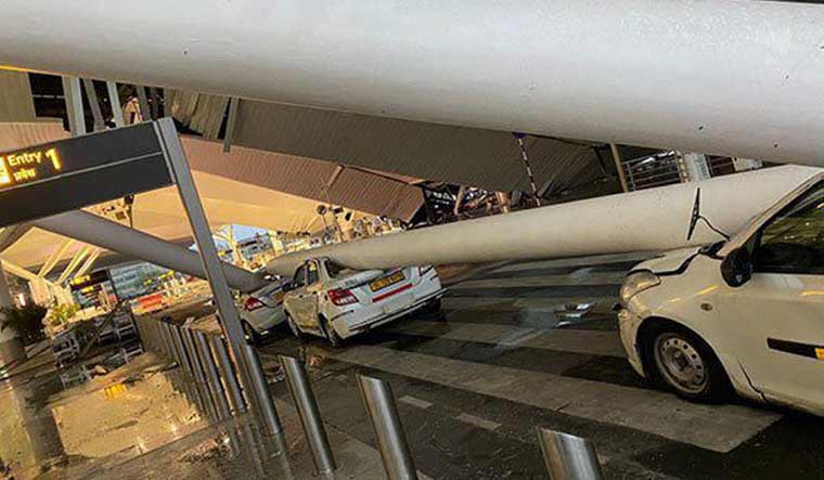 Vehicles crushed after a portion of the roof of the Delhi airport's Terminal-1 collapsed amid heavy rain | PTI