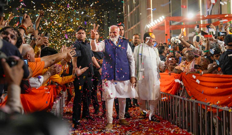 Prime Minister Narendra Modi and BJP National President J.P. Nadda greet supporters upon their arrival for a meeting at the party headquarters in Delhi | PTI