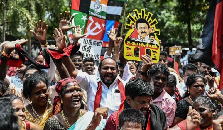 Members of DMK hold a portrait of their president M.K. Stalin as they cheer after the release of vote counts for the Lok Sabha elections at the DMK headquarters in Chennai on June 4, 2024 | AFP