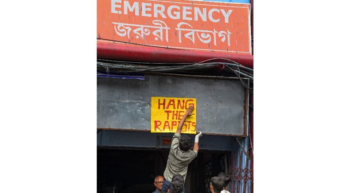 A protestor pastes a poster above the gate of the closed emergency department of RG Kar Medical College Hospital | PTI