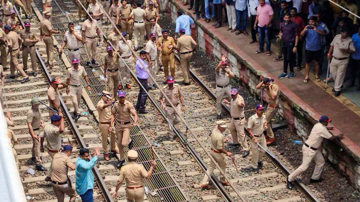 Police personnel try to disperse people blocking railway tracks, at Badlapur railway station, in Thane | PTI
