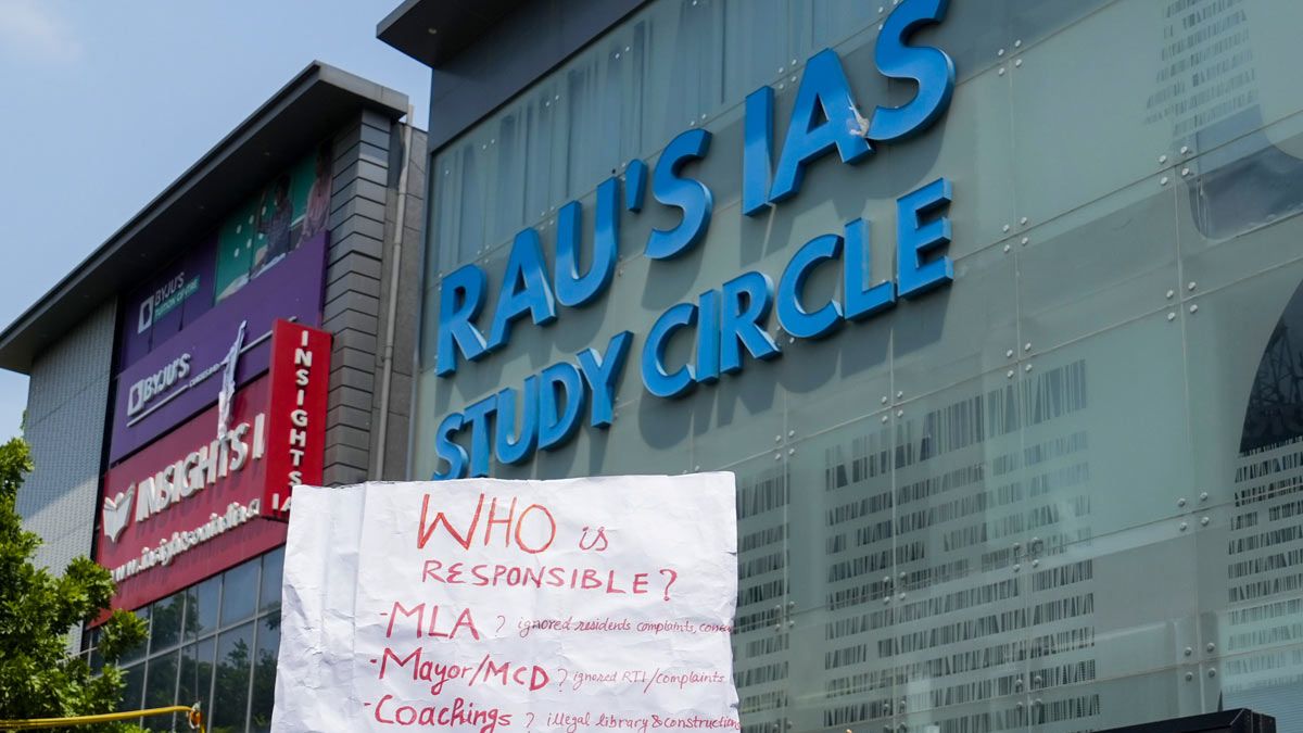 A placard held by a student during a protest after three civil services aspirants died due to drowning at Rau’s IAS Study Circle in Delhi | PTI