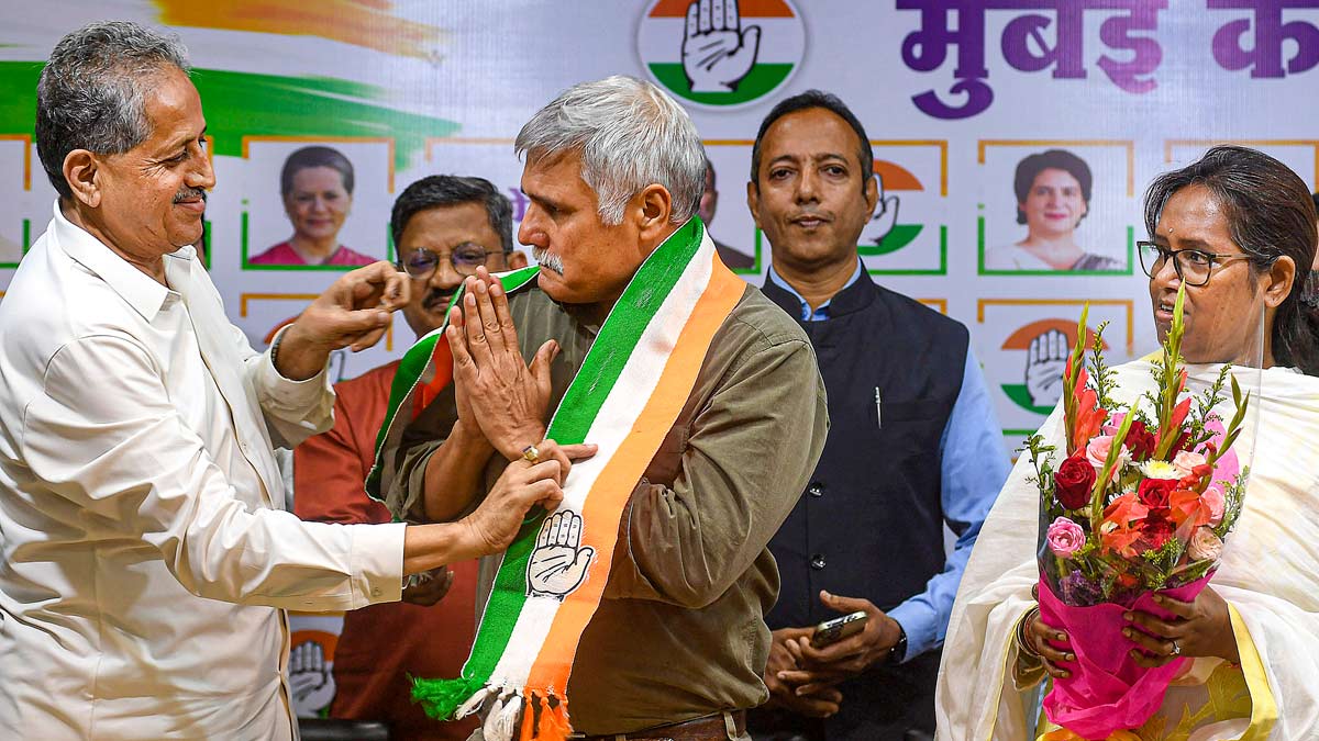 Congress Mumbai unit chief and MP Varsha Gaikwad and party leader U.B. Venkatesh with former Mumbai police commissioner Sanjay Pandey (centre) who joined the party, in Mumbai | PTI