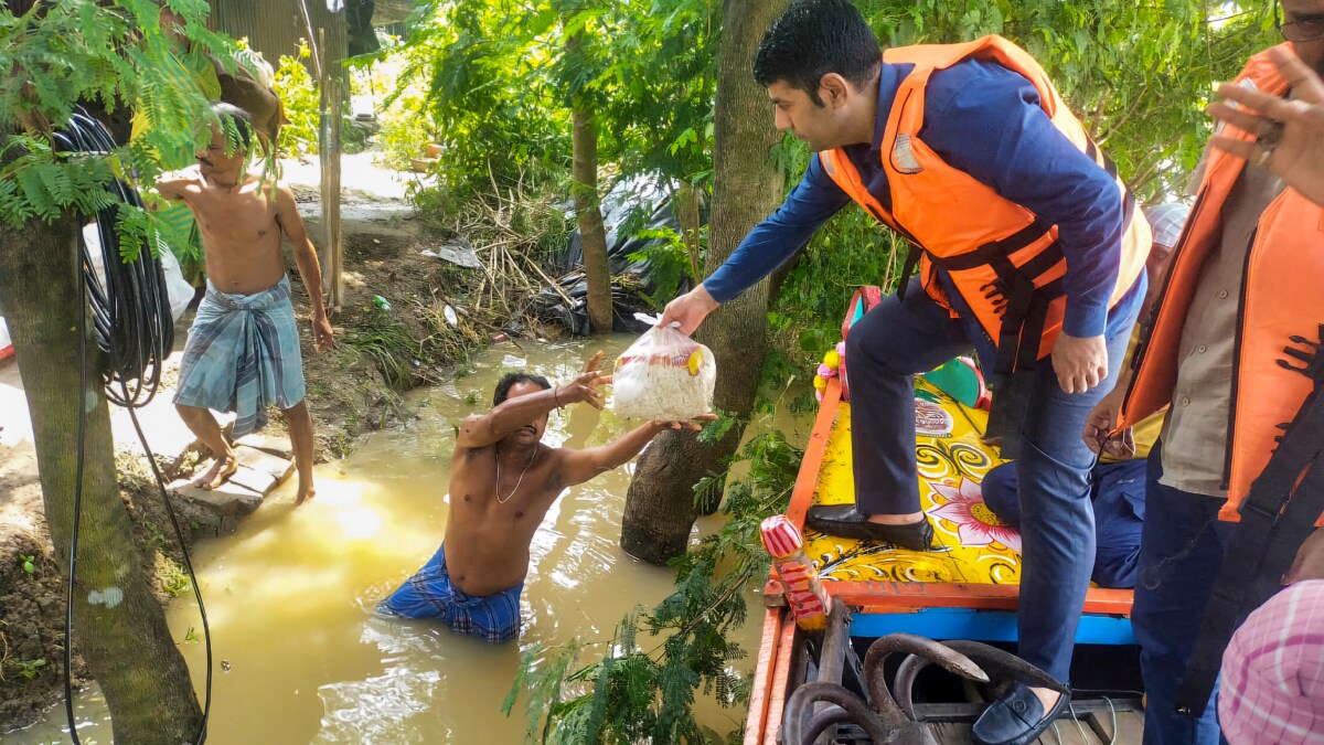 Flood-affected people receive aid, in Paschim Medinipur district, West Bengal | PTI