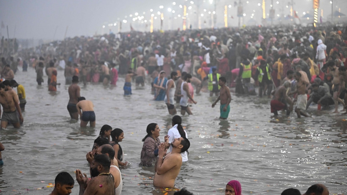Pilgrims take a dip in the sacred waters of Sangam, the confluence of Ganges, Yamuna and mythical Saraswati rivers during the Maha Kumbh Mela festival in Prayagraj | AFP