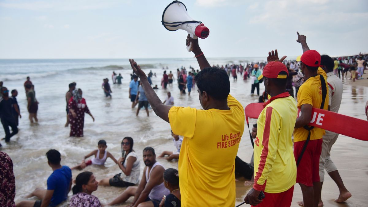 Life guards urge visitors not to venture too deep into the sea in view of 'Cyclone Montha', in Puri, Sunday | X