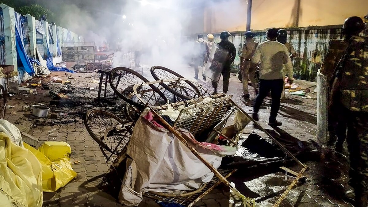 Cuttack: Smoke billows from charred remains of a cart as police and security personnel keep a vigil after fresh incidents of violence linked to a group clash two days ago during a Durga idol immersion procession, in Cuttack, Odisha, Sunday, Oct. 5, 2025. (PTI Photo) (PTI10_05_2025_000399B)
