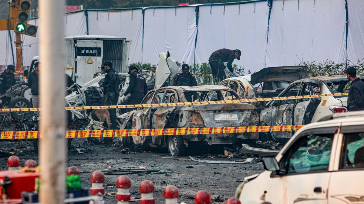  Charred remains of vehicles at a cordoned off area following a blast that occurred near Red Fort Metro Station on Monday | PTI