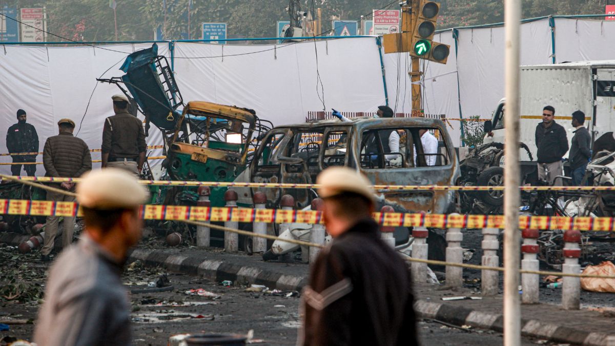 Charred remains of vehicles at a cordoned off area following a blast that occurred near Red Fort Metro Station on Monday, killing at least nine people and gutting several vehicles, in New Delhi | PTI 