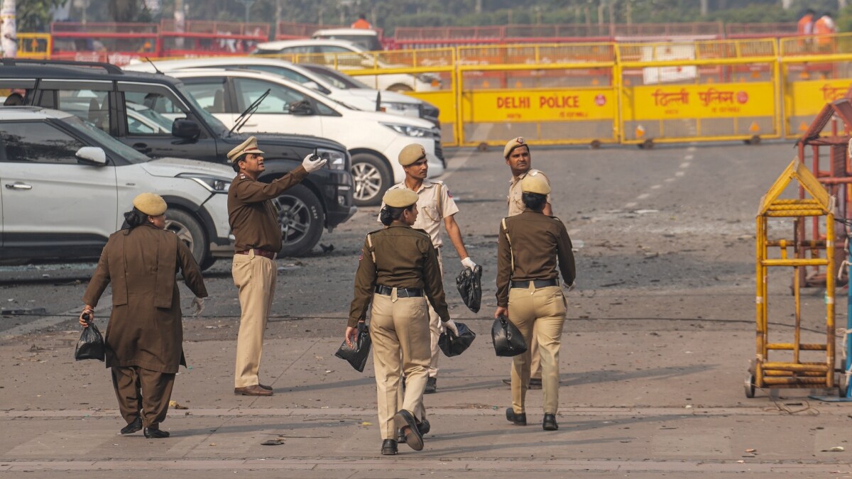 Police personnel search for evidence in the premises of Sri Digambar Jain Lal temple in the aftermath of a blast in the area, opposite Red Fort, in New Delhi | PTI
