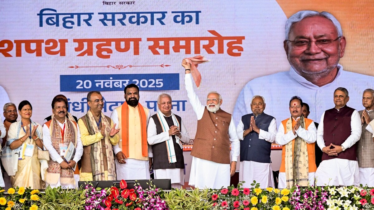 Prime Minister Narendra Modi waves a gamcha during the swearing-in ceremony of NDA government at Gandhi Maidan in Patna | PTI