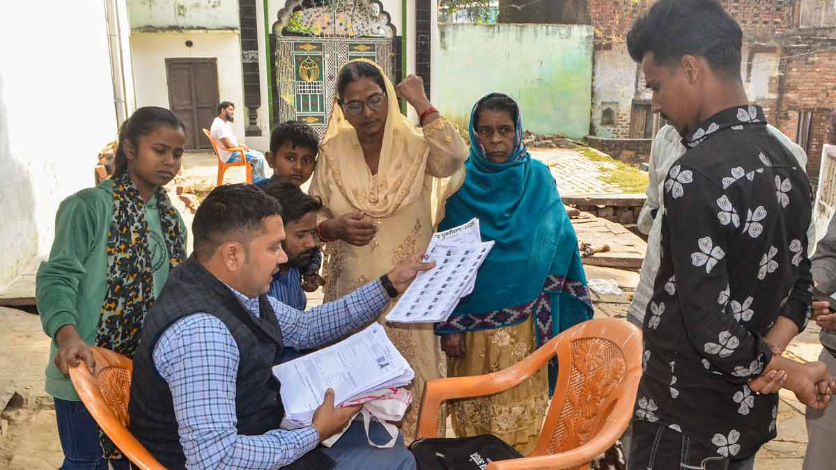 A Booth Level Officer explains the details of enumeration forms to voters  in Mirzapur, Uttar Pradesh | PTI