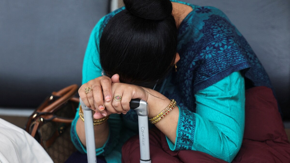 A passenger waits outside the IndiGo Airlines ticketing counter at Terminal 1 of Mumbai's domestic airport after several IndiGo flights were cancelled| Reuters